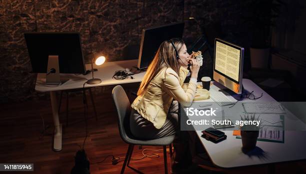 Woman Working Late In Call Center Stock Photo - Download Image Now - 20-29 Years, Adult, Adults Only