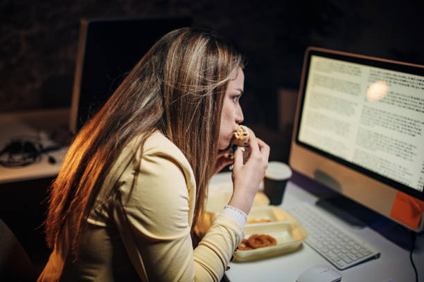 istock Young woman working late 1411816012