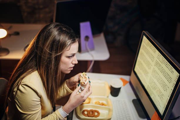 istock Young woman working late 1411816041