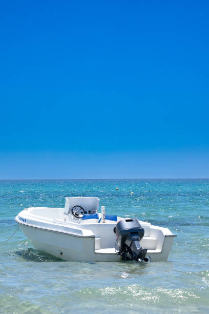motor boat in the sea. Top view of the boat. Top view of a white boat sailing in the blue sea. A boat with a motor on blue water.