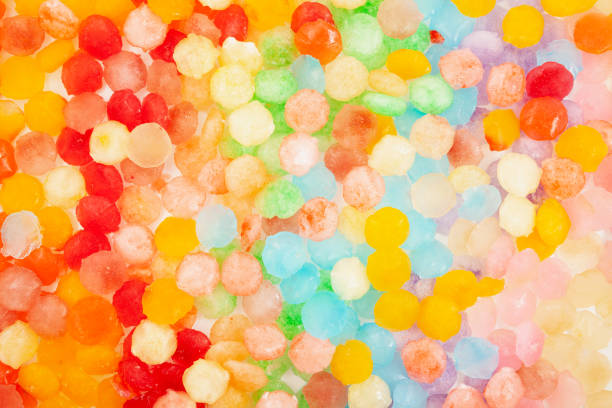 istock Frozen fruit juice. Multi Colored ice cubes. Rainbow ice for cocktail or summer refreshing drinks. Design element 1411817370