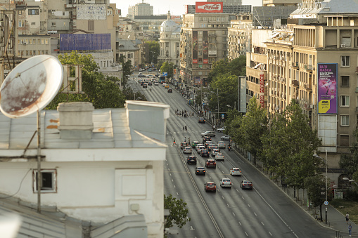 Bucharest, Romania - July 30, 2022: Cars on Magheru boulevard in Bucharest at sunset.