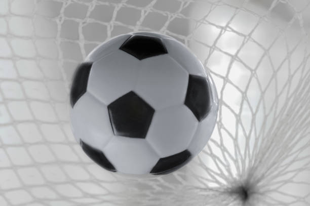 istock Soccer ball on a white mesh in the foreground 1411819889
