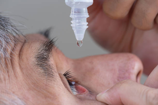 istock A senior Asian man using eye drop in right eye 1411823527