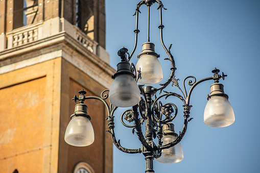 Ancient street lamp in historic city in Rovigo, Italy