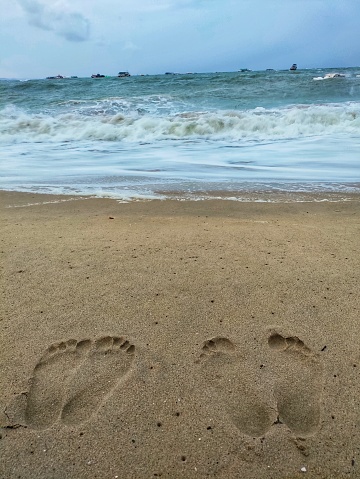 Footprints in the  white sand, sea in distance. Shoab beach, Soqotra, Yemen.