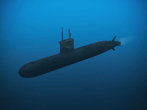 A submarine dives in the sea through clear water.