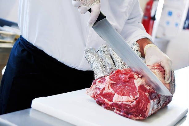 istock Butcher cuts rack of ribeye steak on white cutting board 1411832608