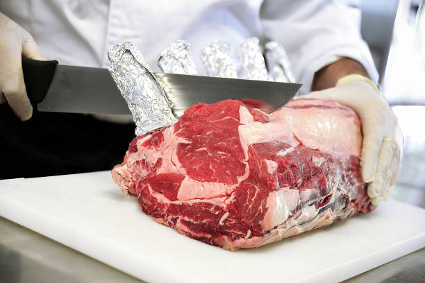 istock Butcher cuts rack of ribeye steak on white cutting board 1411832665