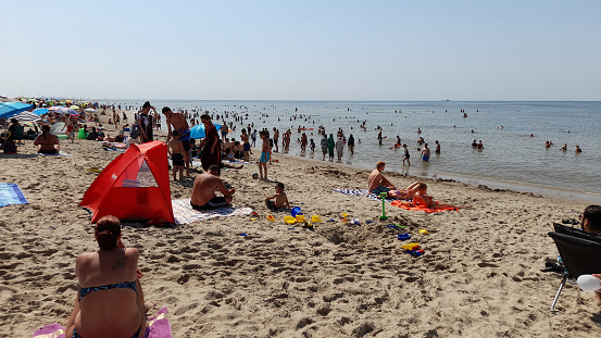 Kijkduin Beach The Hague South Holland The Netherlands Europe, Tourists And Locals Standing, Sitting Down, Walking, Swimming, Laying Down, Looking Around, Taking Picture, Sunbathing, Talking To One Another,  Playing Scene During Record Hot Weather Temperature In Europe