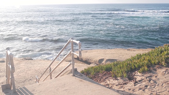 An aerail view of the stunning Corona Del Mar cliffs and coastline looking south to Laguna Beach. Luxury homes along the coastal cliff and stunning rock formations dot the coastline.