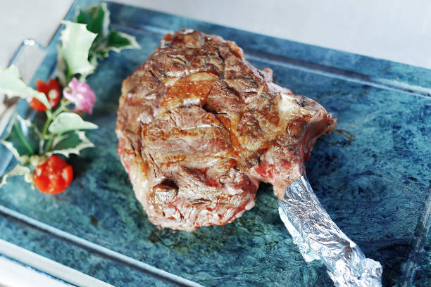 istock Grilled ribeye steak on the bone served whole on stone 1411834328