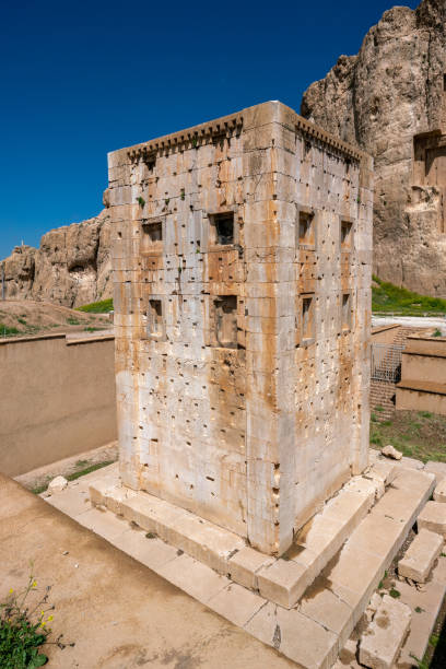 Sandstone rock with carved tombs of persian kings in Necropolis, Iran. King burial site of ancient Persia. Zoroastrian temple. Beautiful sunny day in Persia. stock photo