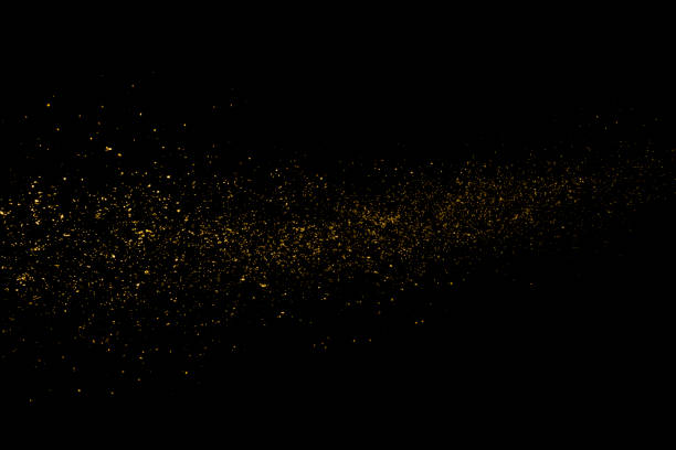 Gold Stardust Gold glittering stardust on black background dust stock pictures, royalty-free photos & images