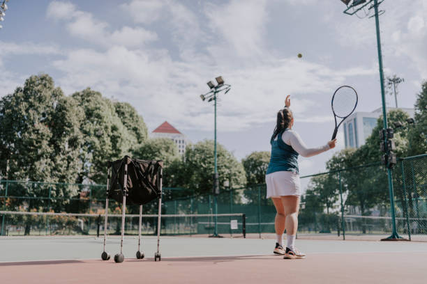 istock chinese female tennis player practicing serving alone 1411837692