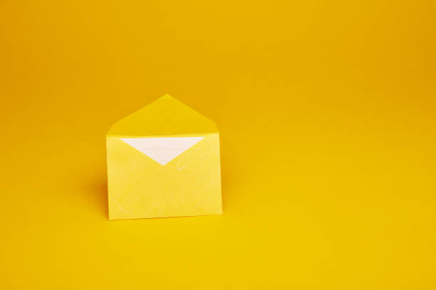 istock Yellow office envelope with lined sheet on the yellow background 1411838794