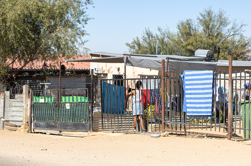 A woman hanging out the washing outside a House at Katutura Township near Windhoek at Khomas Region, Namibia