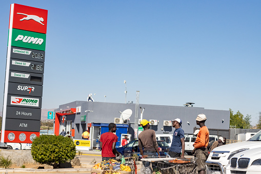 Young Men at Puma Gas Station in Windhoek at Khomas Region, Namibia. A shop is in the background.