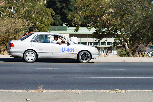 Dili, Timor Leste - February 5, 2012: Taxi passing on the highway Dili, Timor Leste. Transportation in the small country of 1.1 million people, has not had a good transportation system.