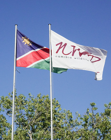 Namibia Wildlife Resorts Flag at Etosha National Park in Kunene Region, Namibia. This is the company that manages the accommodation in Namibia wildlife reserves.