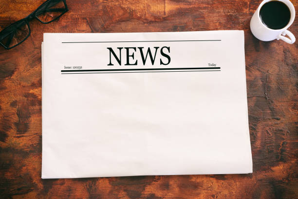 istock Top view image of empty newspaper over wooden table 1411841419