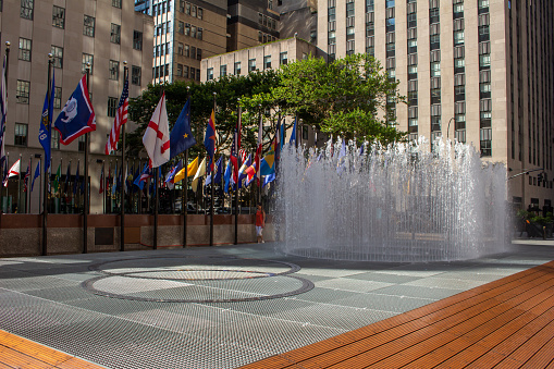New York City, New York, USA - July 19, 2022: Daytime cityscape view of the Changing Spaces water fountain at Rockefeller Center, designed by visual artist Jeppe Heins, and opened in June, 2019 as an interactive water based sculpture.