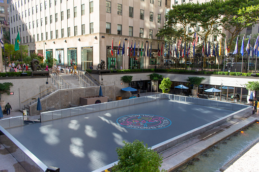 New York City, New York, USA - July 19, 2022: Daytime cityscape view of the winter ice skating rink at Rockefeller Center in Manhattan, New York City. In summer, it is called the Roller Boogie Palace.