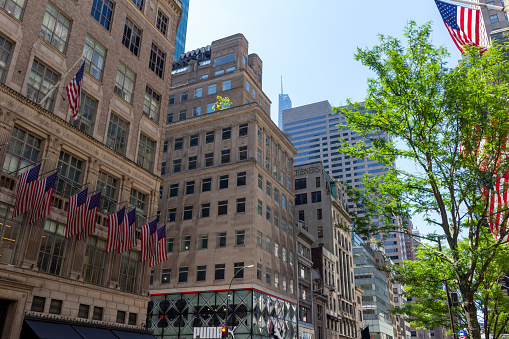 New York City, New York, USA - July 19, 2022: Daytime city street view of buildings on 5th Avenue in the midtown Manhattan business center of New York City.