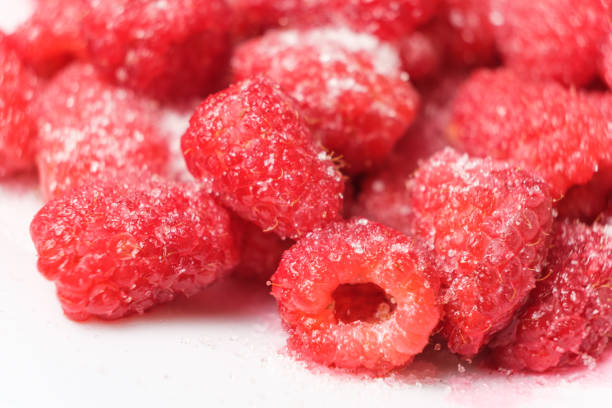 istock Raspberries sprinkled with sugar on a white background, macro photography. 1411844969
