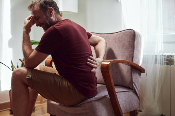 istock Man with back pain and herniated disk at home. 1411846139