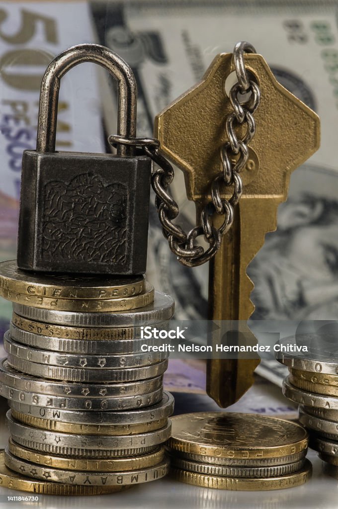 Padlock with chain, coins and bottom dollars Colombia Stock Photo