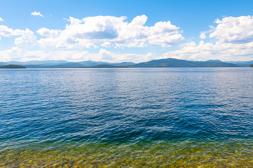 The blue waters of Priest Lake near Cavanaugh Bay, Coolin, Idaho, on a summer day in the Idaho Panhandle.