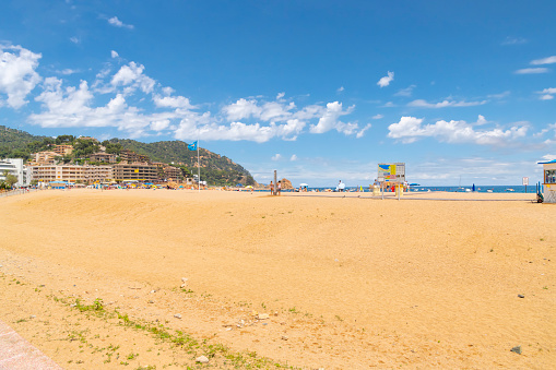 The picturesque sandy beach of Platja Glan along the Costa Brava coastline of the Mediterranean sea at the tourist resort town of Tossa de Mar, Spain.