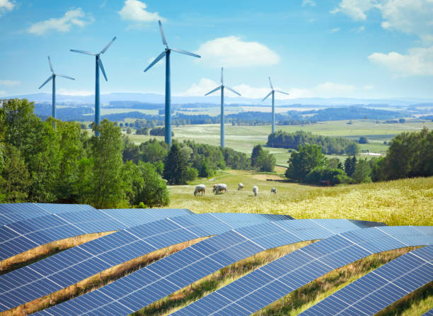 istock Wind turbines and solar panels in the landscape 1411847923