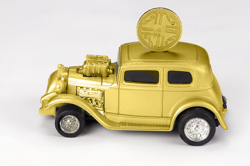 Gold classic car with coin on the roof