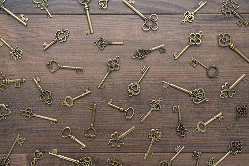 many different vintage keys concept on wooden background