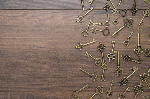 many different vintage keys concept on wooden background with copy space