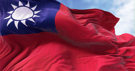 Close-up view of Taiwan flag waving in the wind. Taiwan, officially the Republic of China, is a country in East Asia