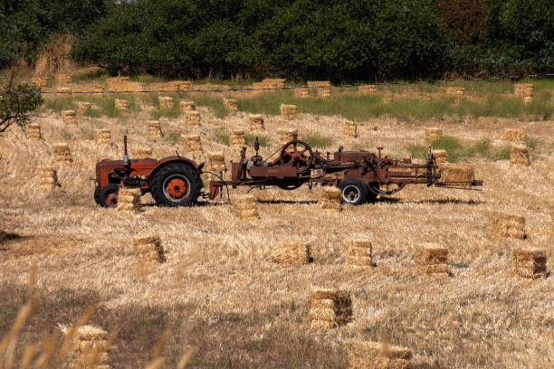Rusty Farm equipment hay bales stock photo