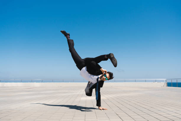 istock Flexible and cool businessman doing acrobatic trick 1411852581