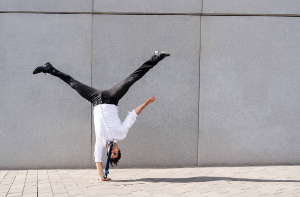 istock Flexible and cool businessman doing acrobatic trick 1411853376