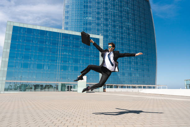 istock Flexible and cool businessman doing acrobatic trick 1411853923