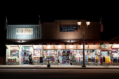 West Yellowstone, Montana - July 17, 2022: The Forever Young gift shopl at night - the area has several tourist gift shops selling souvenirs