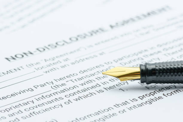 Business legal document concept : Pen on a mutual confidentiality agreement form. Confidentiality agreement is legal contract between 2 or bilateral parties that outlines confidential issues together Business legal document concept : Pen on a mutual confidentiality agreement form. Confidentiality agreement is legal contract between 2 or bilateral parties that outlines confidential issues together co dependent relationship stock pictures, royalty-free photos & images