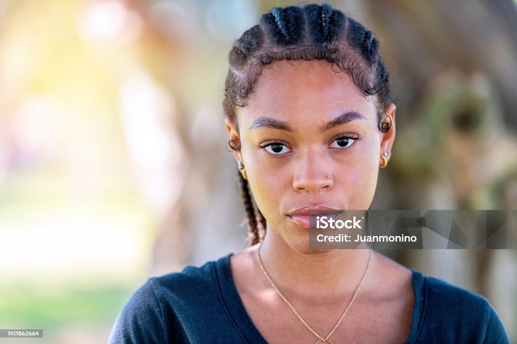 Serious afro-latinx young woman looking at the camera Teenager Stock Photo