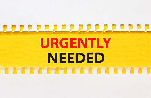 Urgently needed symbol. Concept words Urgently needed on yellow paper on a beautiful white background. Business and urgently needed concept. Copy space.