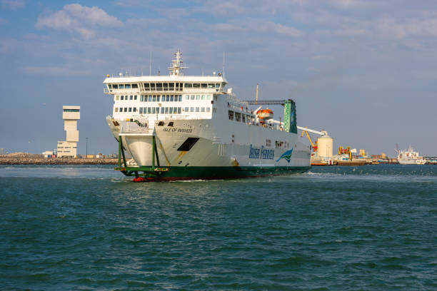 A ferry of the shipping company Irrish Ferries departs from the port of Calais in northern France on the English Channel A ferry of the shipping company Irrish Ferries departs from the port of Calais in northern France on the English Channel, heading for Dover, Great Britain. Calais is a major port city and logistics center from where continental Europe is connected to the UK by sea ferries. Photographed on July 22, 2022. ferry dover england calais france uk stock pictures, royalty-free photos & images