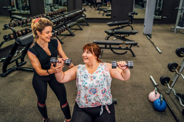 istock Overweight woman having exercise class with a fitness instructor 1411871487
