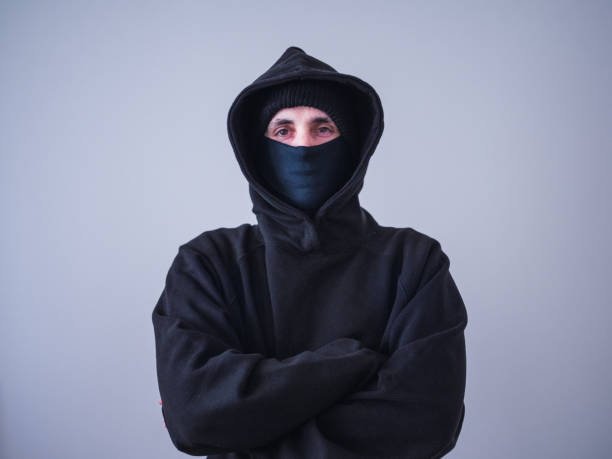 istock Unrecognizable thief in black hoodie and sweatshirt. Security concept 1411877900