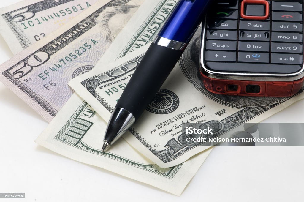 Pen Cell Phone and Dollar Bills American Culture Stock Photo